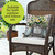 Farmhouse Jars Indoor Outdoor Pillow on wicker chair with white cushion and floral decorative pillow.