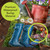 In the Garden Indoor/Outdoor Pillow, blue rain boots, watering can, and flowers on burlap material.