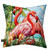 Flamingo Pair Indoor/Outdoor Pillow, pink flamingos on tropical beach scene with palm trees and flowers.