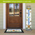 Welcome To Our Home Pine Reversible Porch Leaner with colorful floral and butterfly design standing outdoors.