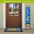 Bee Happy Bugs Pine Reversible Porch Leaner with colorful welcome design and floral accents standing upright.