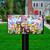 Easter Basket Gnome Mailbox Cover with colorful gnome, eggs, bunnies, and flowers on a lawn.