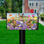 Spring Bunny Trio Mailbox Cover with colorful bunnies, flowers and butterflies on a black mailbox post.
