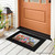 Red White and Beautiful Mini Mat, black border with floral design on a front porch floor.