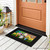 Spring Jubilee Floral Mini Mat with colorful floral design on black background, outdoors by front door.