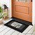 Black Farmhouse Flowers Mini Mat with floral design on front porch beside lantern and potted plant.