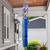 Pansies Windsock Wind Twister with colorful pansy flowers and long blue flowing tail hanging outdoors.