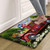 American Pickup Picnic Comfort Mat, red truck design with flowers and picnic items on wood floor.