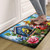 Floral Birdhouses Comfort Mat with colorful birds, flowers, and butterflies design on a vibrant blue background.