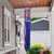 Painted eggs wind sock with Happy Easter design, purple and blue colors, hanging from porch ceiling.