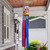 Bucket of Bunnies Windsock Wind Twister with bunnies, blue and pink tails hanging from porch.