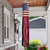 Wooden American Flag Windsock Wind Twister hanging from porch ceiling with red and blue details.
