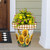 Large Sunflower Duo Planter with yellow flowers and checkered top on a wooden porch step outside.
