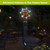 Sunset Parrot Illuminated Wind Chime with colorful parrot design and glowing lights at night.