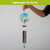 Welcome Butterflies Illuminated Wind Chime with colorful butterflies and black tubes, held by a hand.