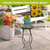 Country Birds Plant Stand with colorful pot and flowers on a small outdoor table setting.
