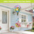 Sunshine Butterflies Hot Air Balloon Spinner with colorful butterflies and flowers hanging from a porch ceiling.