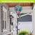 Springtime Hummingbirds Hot Air Balloon Spinner with colorful hummingbird design on blue background outdoors.