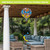 Colorful Checkered Butterflies Hot Air Balloon Spinner hanging from outdoor patio pergola with furniture.
