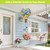 Bluebirds and Roses hot air balloon spinner with blue, gold, and pink decorations hanging outdoors.