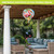 Flamingo Pair Hot Air Balloon Spinner outdoor patio decoration with colorful flamingos and greenery background.