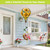 Sunflower Duo Hot Air Balloon Spinner with floral design and green spiral hanging from a porch.