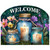 Be a Light Jars Acrylic Art Sign with lit candles and welcome text on floral background.