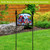 Home of the Free Birdhouses colorful acrylic art sign on a decorative black garden sign stand.