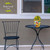 Briarwood Lane Birds in the Garden Small Planter with yellow flowers on a black metal table.