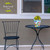 Briarwood Lane Sunshine Butterflies small planter on a table with a black chair nearby outdoors.