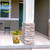 Sunflower Duo Medium Planter with yellow flowers on a front porch beside a pillar outdoors.
