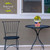 American Flower Field Small Planter with yellow flowers on a black metal table and chair setting.