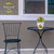 Briarwood Lane Country Home Sweet Home Small Planter with yellow flowers on a black metal table.