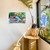 Large LED canvas art with colorful flowers and birds, Feathered Friends, on a white wall.