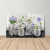 Large LED canvas art of white and purple flowers in checkered mason jars on wooden backdrop.