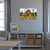 Large LED canvas art of a red barn with sunflowers, mounted on a living room wall.