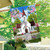 Church in Spring House Flag with white church, red roof, flowers, and picket fence design.