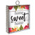Farmhouse metal mini moment sign with "home sweet home" text and colorful floral design.