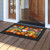 Gnome and Pumpkins doormat on wooden porch with colorful design and black border and frame.