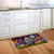 Halloween Pumpkin Stack Doormat on wooden floor in front of white kitchen cabinets and sink.