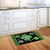 Scattered Shamrocks Doormat with green shamrocks and "Happy St. Patrick's Day" text on black background.