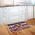 Patriotic Highland Cow Doormat on wooden floor in front of white kitchen cabinets with brown countertop.