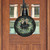Round black wood door hanger with floral wreath and Home Sweet Home text on a door.