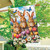 Brown bunnies and colorful flowers on Bunny Greeting House Flag with butterflies and blue sky background.