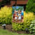 Summer Chipmunks Garden Flag with cartoon chipmunks in hats on a tropical background outdoors.