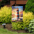 Lighthouse At Sunset garden flag with red and white striped lighthouse and seagulls in flight displayed.