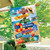 Beach Signs House Flag with colorful beach themed design and text on a garden flag outdoors.