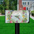 Hummingbird Wreath Mailbox Cover with colorful flowers, hummingbird, and welcome sign on a black mailbox.