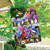 Bird Watching House Flag with colorful birds, flowers, and bird feeder on fence outdoors.