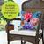 Butterflies and Peonies Indoor/Outdoor Pillow on wicker chair with colorful floral butterfly design.